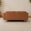 A back view of a Hugo vegan suede 2 seater lounge on a beige woven rug