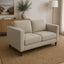Sam 2 seater fabric couch in a small apartment living room